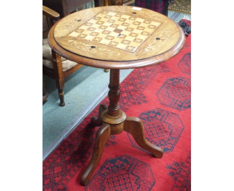 An inlaid games table on tripod base Condition Report: Available upon request