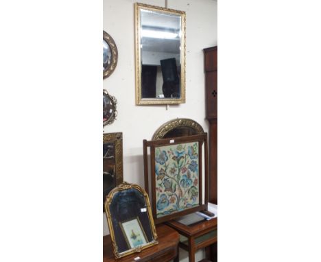 An oak framed tapestry firescreen and two gilt mirrors (3) Condition Report: Available upon request
