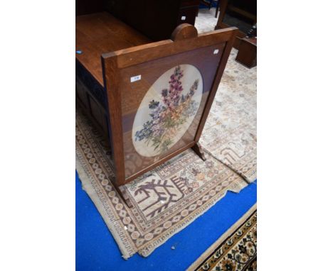 An early 20th Century oak framed firescreen with embroidered panel
