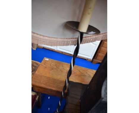 A wrought iron standard lamp