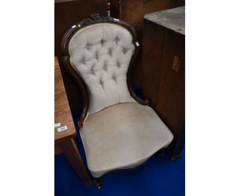A Victorian spoon back nursing chair having later button back dralon upholstery