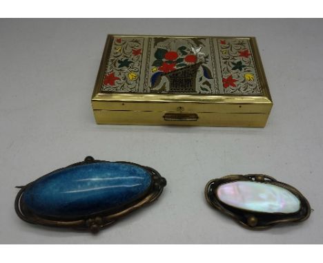 A musical compact and two Art Nouveau brooches, mother of pearl and Kensington art ware