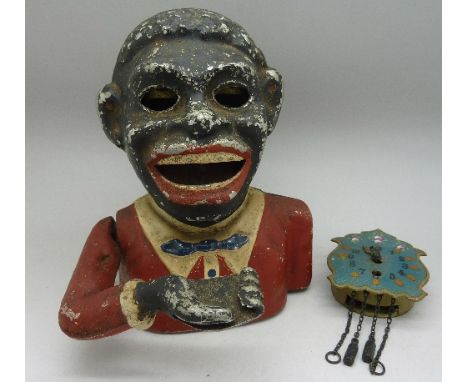 A cast money bank and an enamel dialled clock