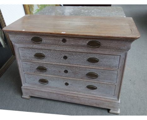 An early 19th century French later limed oak commode of four long graduated drawers, on splayed block feet, 126cm wide.