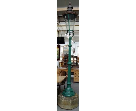 A Victorian copper street lantern of tapering cylindrical form, on a green painted cast iron cluster column and carved stone 
