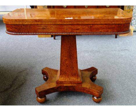 A George IV figured walnut card table on flared square column and quatrefoil platform, 92cm wide.