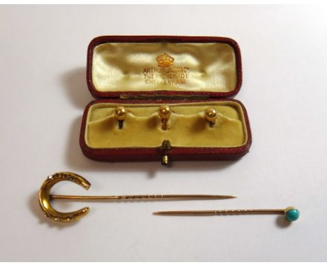 A gold and diamond set stick pin, the finial designed as a horseshoe, mounted with seven rose cut diamonds, a turquoise set s