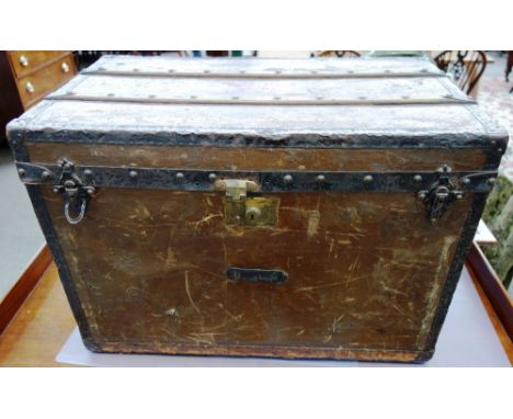 A Louis Vuitton style cabin trunk, late 19th century, with applied black metal furnishings, wooden slats and two leather carr
