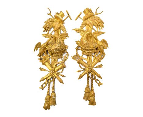 A pair of giltwood wall appliques, 19th century, carved with crossed rake and pitchfork, with sheaves of wheat over birds nes