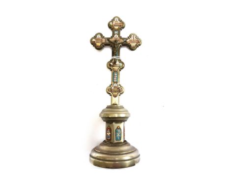 A silvered brass table crucifix of Gothic form, 20th century, inlaid all over with mosaic panels depicting architectural scen