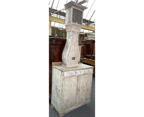 A 19th century Swedish white painted and floral carved commode horloge, the square dial above bellied trunk, the base with th