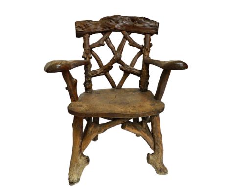 A George III open armchair, the naturalistic interlaced yew back over solid elm seat.  Illustrated