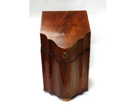 A George III mahogany slope fronted serpentine knife box, with original adapted cutlery matrix interior, 22cm wide together w