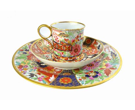 A Flight & Barr, Worcester `Japan' pattern coffee can, saucer and plate, circa 1800, brightly painted with panels of flowers 