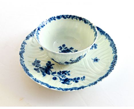 A Worcester blue and white teabowl and saucer, circa 1760, painted with the `Feather moulded Floral' pattern, blue workman's 