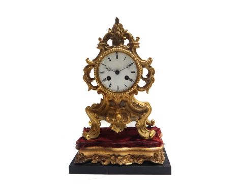A French ormolu mantel clock, 19th century, the scroll case centred by a white enamel dial, enclosing a two train movement an
