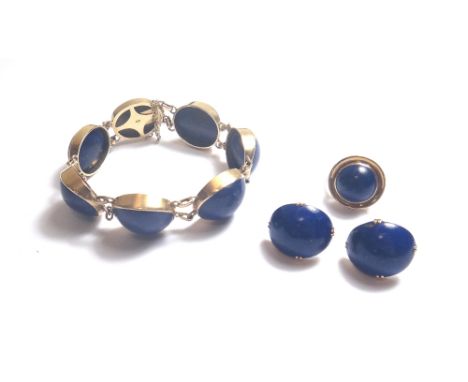 A gold mounted lapis lazuli set bracelet, the links mounted with oval lapis lazuli cabochons and on an oval snap clasp engrav