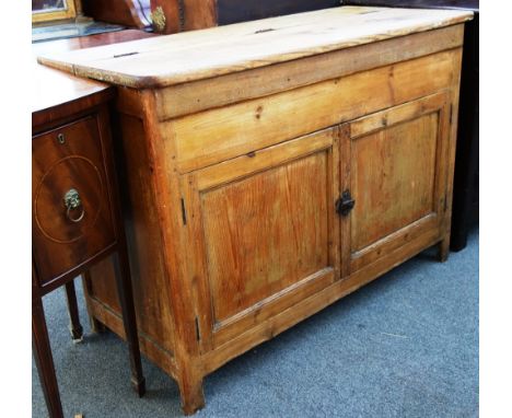 An 18th century pine side cabinet, the lift top over a pair of panel cupboards, on block feet, 130cm wide.