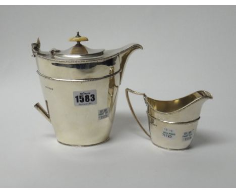 Silver, comprising; a hot water jug, of tapering oval form, with an ivory finial and handle (the ivory handle detached), with
