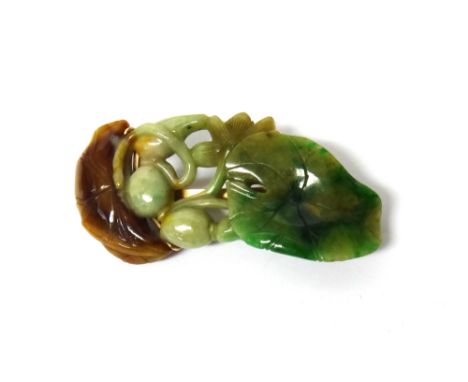 A gold mounted carved green and brown jade brooch, designed as a lily, the mount detailed 14K Yenson, length 7cm.