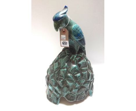 A Doulton pottery speaker cover, circa 1920, manufactured for Artandia Ltd and modelled as a Cockatoo atop a rocky mound (a.f