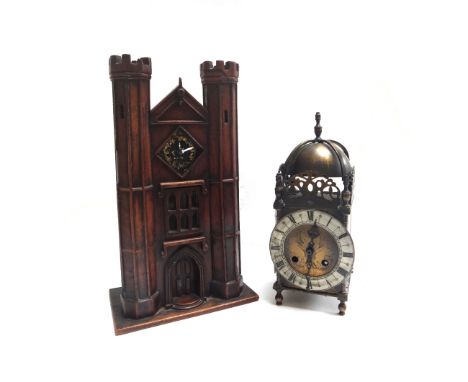 A stained pine cased mantel clock, early 20th century, modelled as a castle gatehouse, 32cm high, together with a reproductio