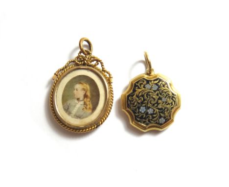 A Victorian gold and enamelled shaped circular pendant mourning locket, glazed with a locket compartment within, the exterior