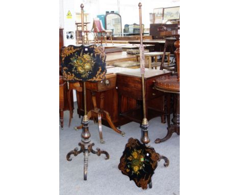 A pair of Victorian polychrome painted papier mache pole screens, on tripod bases. 