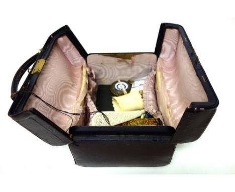 A miniature Gladstone burgundy coloured leather case by Asprey, containing; an openfaced pocket watch, a miniature shoe, a tr