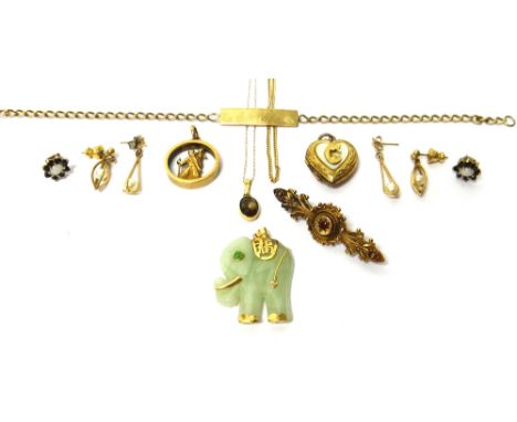 A gold and red gem set bar brooch, detailed 15ct, a 9ct gold St Christopher pendant, a carved jade pendant, designed as an el