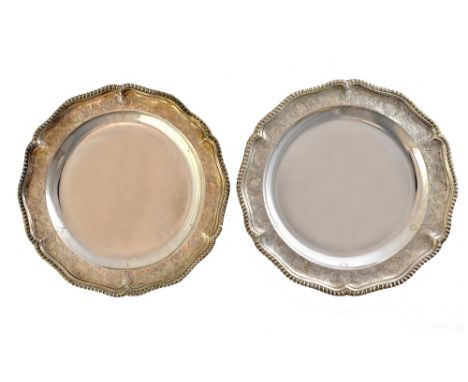 A pair of George III silver second course dishes, bearing the mark of Charles Wright, London 1776, of shaped circular form wi