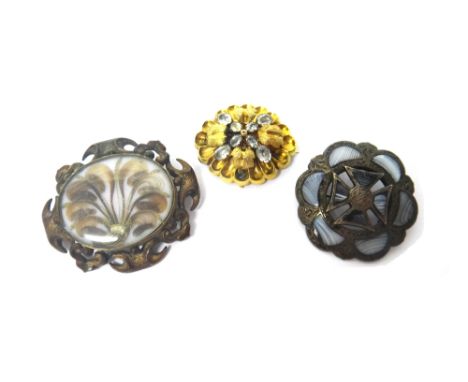 A Victorian gold and foil backed pale blue gem set shaped oval brooch, decorated with foliate motifs, a banded grey agate set