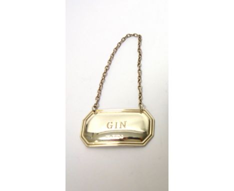 A silver cylindrical container, detailed B, London 1949, a silver heart shaped pill box, a silver decanter label detailed GIN