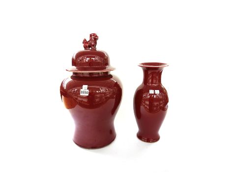 A pair of modern Chinese temple vases and covers of baluster form, each with dog of Fo finial and sang de boeuf glaze, 48cm h