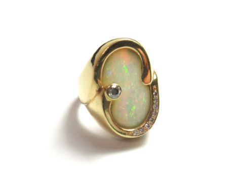 A gold, opal and diamond set ring, in an abstract design, mounted with the principal circular cut diamond to the side of the 