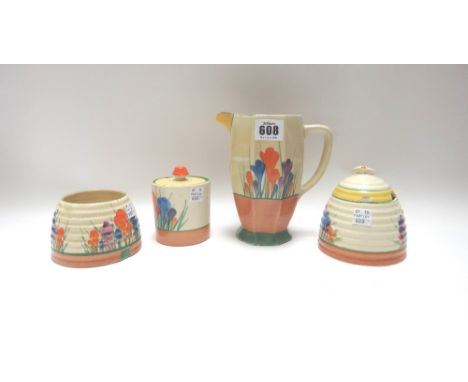 Four pieces of Clarice Cliff pottery decorated in the 'Crocus' pattern, comprising; an octagonal jug, 15.5cm high, a preserve