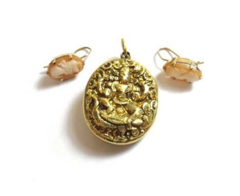 An Eastern gold oval pendant locket, decorated with deity figures, gross weight 11.7gms and a pair of 9ct gold mounted oval s