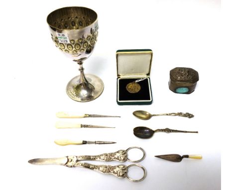 A silver book marker, formed as a trowel, having a mother of pearl handle, Birmingham 1902, a silver model of The Coronation 