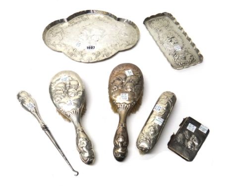 Silver and silver mounted wares, comprising; a shaped oval dressing table tray, decorated with cherubs' faces within borders 