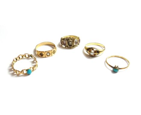 A gold and enamelled ring, claw set with a half pearl within a black enamelled surround, a gold ring, mounted with a central 