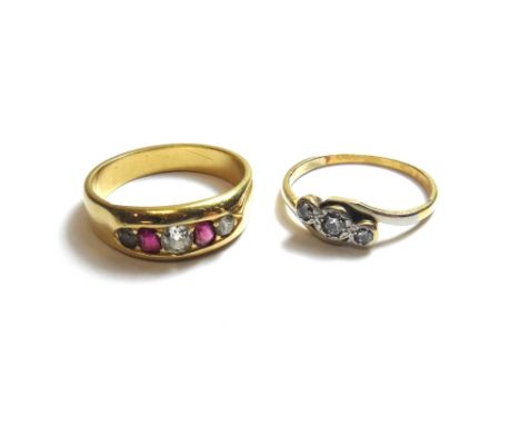 A gold, ruby, diamond and colourless gem set five stone ring, mounted with two cushion shaped diamonds, two cushion shaped ru