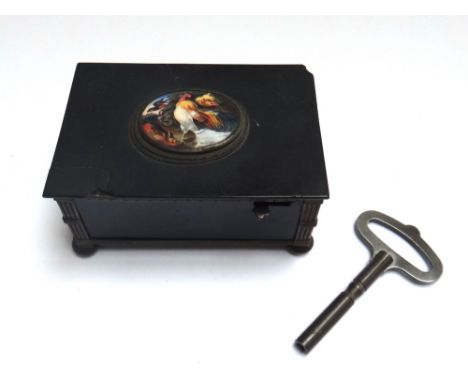 A Continental black lacquered musical box, 19th century, the enamel oval lid decorated with singing wild birds opening to rev