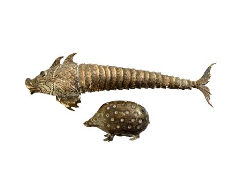 A silver pin cushion, designed as a hedgehog, Birmingham 1904 and a foreign model of an articulated fish with cabochon green 