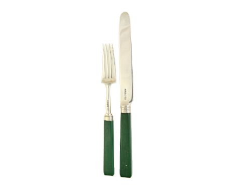 A set of twelve pairs of silver dessert or fruit knives and forks, having green stained ivory handles, London 1823.  Illustra
