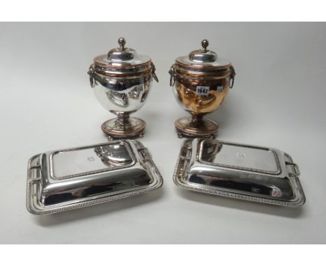 A pair of plated on copper twin handled lidded urns, each of oval form with a spherical finial, lion mask handles and raised 