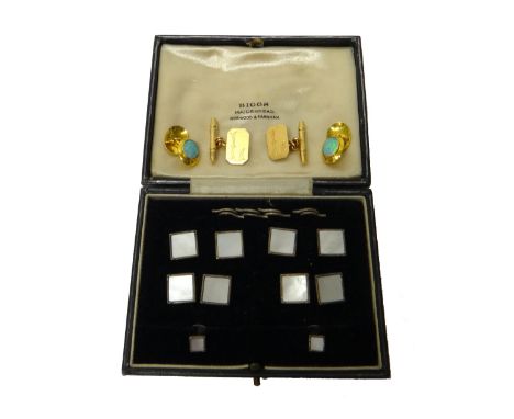 A pair of opal set oval dress cufflinks, a pair of gold cufflinks, the cut cornered rectangular fronts engraved with the init