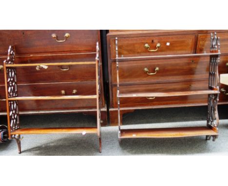 A 19th century mahogany serpentine three tier hanging wall shelf with fret cut sides, 68cm wide, together with another simila