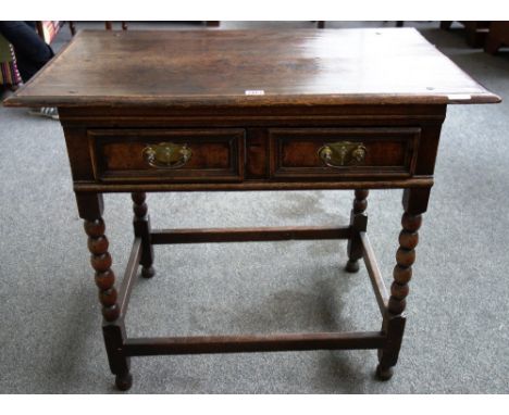 A late 17th century oak side table, the single moulded drawer on bobbin turned supports, 83cm wide.