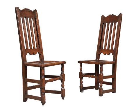 A PAIR OF OAK SIDE CHAIRS EARLY 18TH CENTURYOf slightly differing proportion, each with four vertical splatsPlease note the f