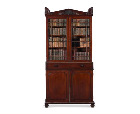 A REGENCY MAHOGANY SECRETAIRE BOOKCASECIRCA 1825The doors opening to adjustable and fixed shelving, the secretaire drawer hin